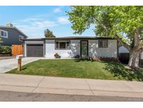Charming single-story home with well-manicured lawn, garden, and a one car garage at 251 Norse St, Golden, CO 80401