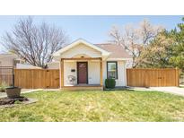 Charming single-story home featuring a welcoming front porch and well-maintained lawn at 851 Quitman St, Denver, CO 80204