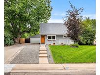 Charming gray home boasts a manicured lawn and inviting front porch, enhancing its curb appeal at 2535 S Julian St, Denver, CO 80219
