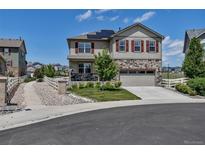 Charming two-story home featuring stone accents, a two-car garage, and manicured front yard at 5789 Echo Park Cir, Castle Rock, CO 80104
