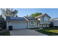 Charming single Gathering home featuring solar panels, attached garage, and well-maintained landscaping at 21225 E Powers Ave, Centennial, CO 80015