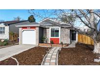 Charming single-Gathering home features a brick and gray exterior with a well-manicured front yard at 3071 S Truckee St, Aurora, CO 80013