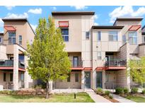 Contemporary townhome featuring balconies, patios, modern design elements, and well-maintained landscaping at 8953 E Northfield Blvd, Denver, CO 80238