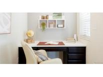 Bright home office with built in desk and shelving, perfect for working from home at 8953 E Northfield Blvd, Denver, CO 80238