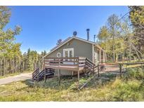 Beautiful home exterior featuring a cozy deck area, perfect for enjoying mountain views at 32252 Steven Way, Conifer, CO 80433