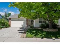 Charming single-Gathering home with mature tree, two-car garage, and well-maintained lawn at 9747 W Peakview Dr, Littleton, CO 80123