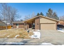 Charming single-story brick home with a well-manicured front yard and attached two-car garage at 1843 S Pierson Ct, Lakewood, CO 80232