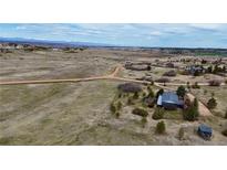 Expansive aerial view showcases the property's serene country setting and rolling landscape at 2130 Frontier Ln, Franktown, CO 80116