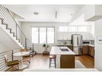 Modern kitchen with stainless steel appliances and island at 1218 Perry St, Denver, CO 80204