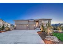 Beautiful single-Gathering home featuring a spacious driveway, stone accents, and a two-car garage at 4213 Hickory Oaks St, Castle Rock, CO 80104