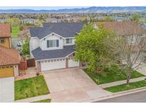 Charming two-story home featuring a three-car garage and well-maintained lawn at 6614 W Gould Dr, Littleton, CO 80123