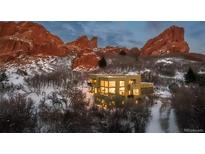Breathtaking two-story home featuring expansive windows and set against a stunning rock formation backdrop at 5668 Red Fern Ct, Littleton, CO 80125