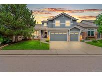 Charming two-story home with a manicured lawn and a three-car garage in a desirable neighborhood at 3075 Greensborough Dr, Highlands Ranch, CO 80129