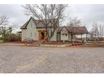Charming home boasts unique architecture, beautiful landscaping, and an inviting gravel driveway at 13200 E 160Th Ave, Brighton, CO 80602