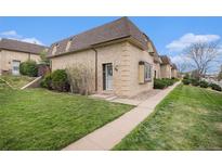Charming brick home with well-maintained lawn and mature landscaping, showcasing curb appeal at 5573 S Lowell Blvd, Littleton, CO 80123
