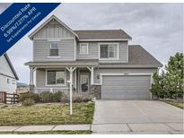 Charming two-story home featuring a covered porch, two-car garage, and well-maintained landscaping at 8695 Torrey St, Arvada, CO 80007