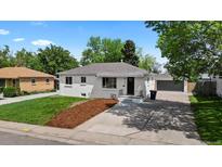 Charming single-story home with fresh landscaping, newly painted exterior and detached garage in the back at 2542 S Winona Ct, Denver, CO 80219