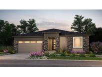 Charming single-story home boasting stone accents, a two-car garage, and beautifully landscaped front yard at 39575 Gwinett Cir, Elizabeth, CO 80107