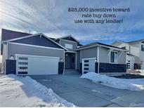 Charming single-Gathering home featuring a two-car garage, attractive stonework, and a well-maintained driveway partially covered in snow at 42978 Colonial Trl, Elizabeth, CO 80107