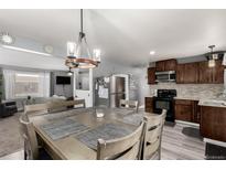 Charming kitchen featuring a dining table with pendant lighting and stainless steel appliances at 117 6Th St, Frederick, CO 80530