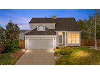 Charming two-story home features a two-car garage, stone accents, and well-maintained landscaping at 8164 S York Ct, Centennial, CO 80122