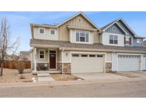 Charming two-story home featuring a two-car garage and inviting front porch at 9777 W Stanford Ave, Denver, CO 80123