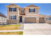 Inviting two-story home featuring neutral siding, a three-car garage, and a well-manicured front lawn at 6880 S Yantley Ct, Aurora, CO 80016
