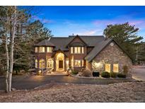 Stunning two-story home featuring stone accents and a well-manicured front yard in a picturesque location at 30205 Telluride Ln, Evergreen, CO 80439
