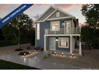 Two-story craftsman style home with gray siding, balcony, and landscaping at 13543 E 103Rd Ave, Commerce City, CO 80022