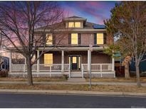 Charming brick home with a welcoming front porch and well-maintained landscaping at 8805 E 28Th Ave, Denver, CO 80238