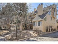 Charming townhouse exterior with multiple levels, wood siding, and mature trees at 4832 E Kentucky Ave # E, Denver, CO 80246