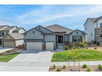 Charming home featuring a well-manicured lawn and a spacious three car garage at 18212 W 95Th Pl, Arvada, CO 80007