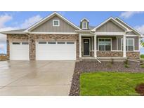 Charming single Gathering home featuring stone accents, a two car garage, and a well-manicured lawn at 1818 Sawtooth Mountain Dr, Berthoud, CO 80513