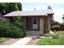 Charming brick home featuring a well-maintained front yard and covered entryway at 2902 Depew St, Wheat Ridge, CO 80214