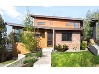 Contemporary home featuring a unique design with mixed materials and a well-manicured front yard and inviting front entrance at 5134 Quitman St, Denver, CO 80212