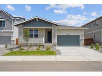 Charming single-Gathering home with manicured lawn, gray accents, and attached two-car garage at 45933 Wood Thrush Ave, Bennett, CO 80102
