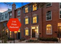 Beautiful brick townhome with blue shutters and well-maintained landscaping after a 71K price reduction at 479 Josephine St, Denver, CO 80206