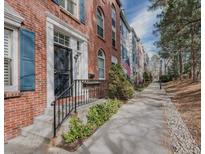 Charming brick townhome featuring a landscaped walkway and classic architectural details at 479 Josephine St, Denver, CO 80206