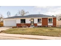 Brick ranch home with attached garage and landscaped lawn at 4612 S Coors Ct, Morrison, CO 80465