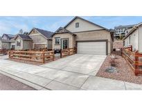 Charming single-Gathering home featuring a two-car garage, nice wood fence, and a well-manicured yard at 692 Sage Forest Ln, Monument, CO 80132