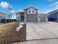 Charming two-story home with a three-car garage and well-maintained front yard at 16186 Sequoia Dr, Parker, CO 80134