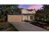 Inviting home featuring a spacious driveway and attached garage at 308 Oswego St, Aurora, CO 80010