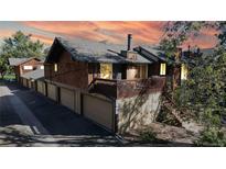 Inviting home features a deck, three-car garage, and wood exterior at 1242 S Crystal Way, Aurora, CO 80012