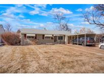 Charming single-story home with a tidy front yard and a convenient covered parking area at 3423 S Glencoe St, Denver, CO 80222