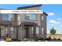 A modern two-story home featuring a covered front porch and a combination of siding and stone accents at 6393 N Malaya St, Aurora, CO 80019