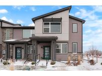 Modern townhome with a neutral color scheme, partial stone accents and a covered front entryway at 6393 N Malaya St, Aurora, CO 80019