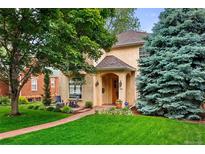 Charming home with a well-manicured front yard, beautiful trees, and a welcoming entrance at 2411 S Milwaukee St, Denver, CO 80210