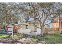 Charming two-story home with mature trees, front yard, and welcoming entrance at 153 S Grant St, Denver, CO 80209