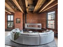Beautiful living room with exposed brick, wood ceilings and modern fireplace at 1628 14Th St # 6A, Denver, CO 80202