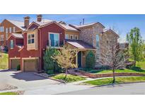 Charming home featuring a stone and stucco facade, balcony, attached garage, and well-maintained landscaping at 9588 Firenze Way, Highlands Ranch, CO 80126
